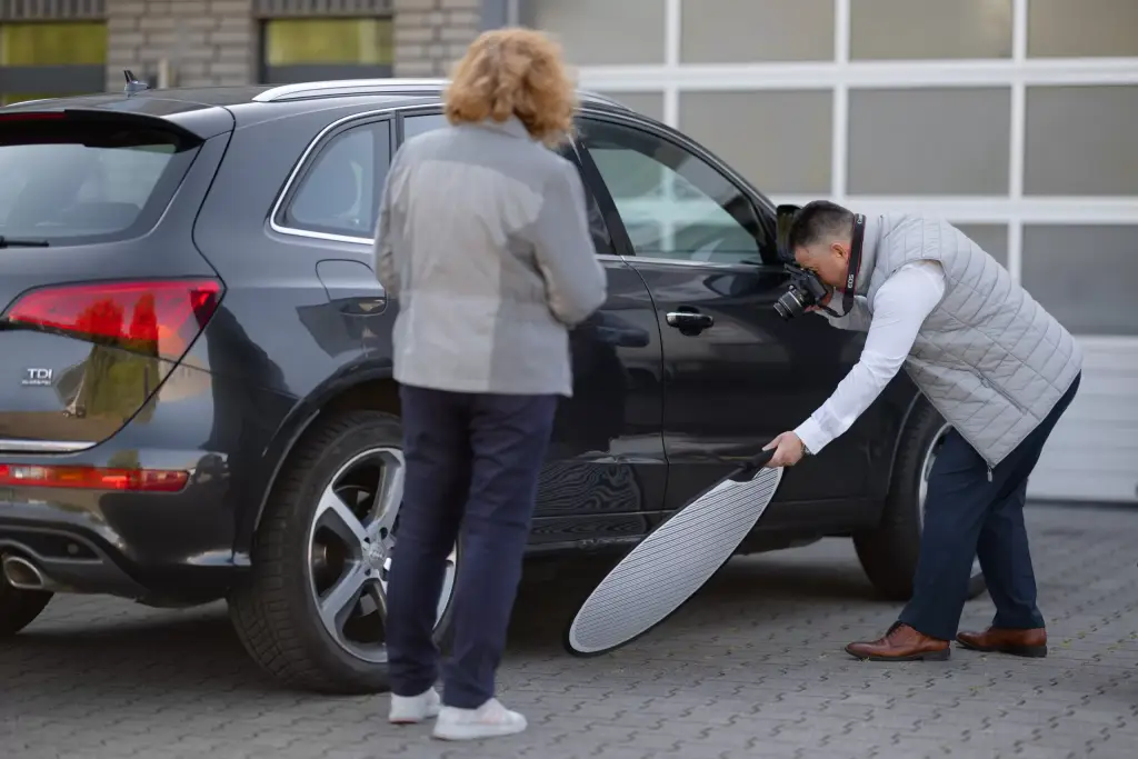 Autogutachter für sitzt am Schreibtisch und schreibt Autogutachten